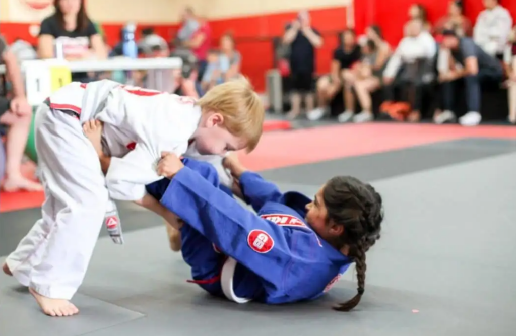 Kids taking part in a BJJ competition match white belt kids