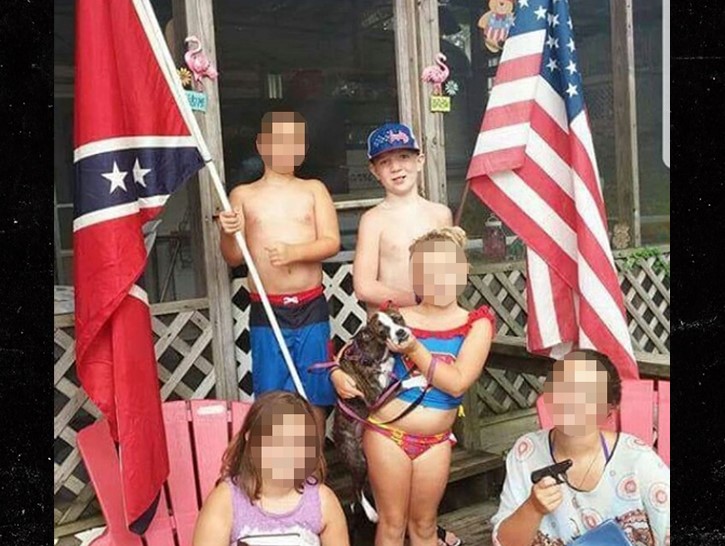 Keaton holding an U.S. Flag and other kid holding Confederate Flag