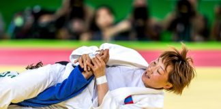 Brazilian Jiu Jitsu woman doing an armbar on her opponent