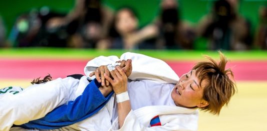 Brazilian Jiu Jitsu woman doing an armbar on her opponent