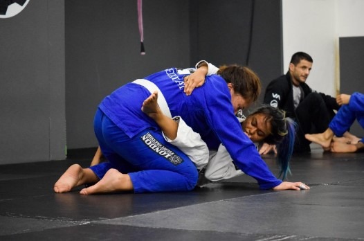 Woman in Closed Guard Trying a Sweep