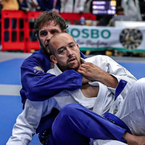 Tom Hardy successfully maintains the back position and attempts to secure a choke.