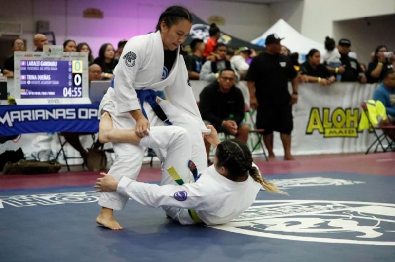 BJJ athletes competing in a sport-focused tournament, showcasing ground-based strategies