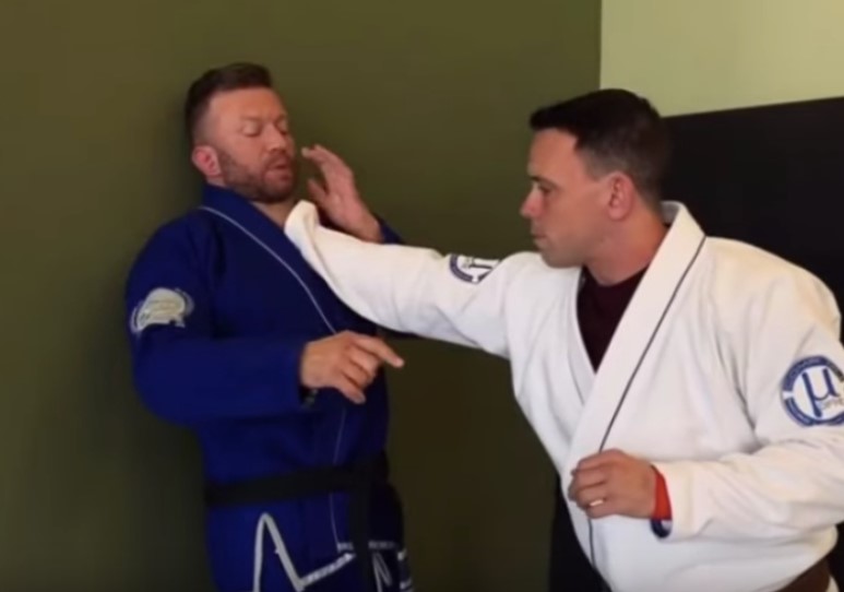 A BJJ practitioner demonstrating self-defense techniques, including strikes and takedowns