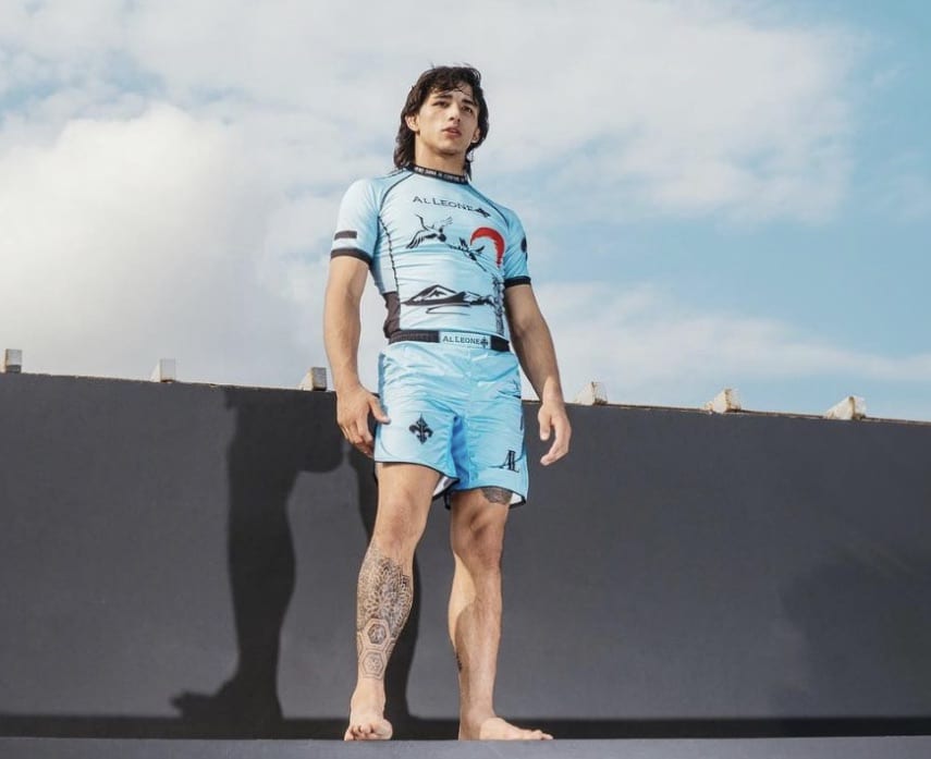 Jozef Chen outdoor photoshoot in sky blue “Al Leone” rash guard with cloudy blue background 